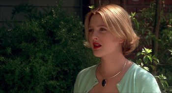 Movie still from “The Wedding Singer” (1998), directed by Frank Coraci – A woman with blonde hair wearing a necklace; Close Up shot, Over the shoulder angle