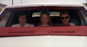 Movie still from “The Wedding Singer” (1998), directed by Frank Coraci – A group of people sitting in the back of a car; Medium shot, Over the shoulder angle