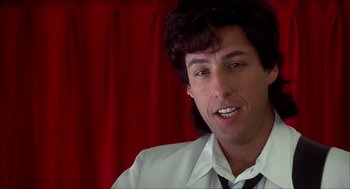 Movie still from “The Wedding Singer” (1998), directed by Frank Coraci – A person wearing a suit and tie; Close Up shot, Low angle