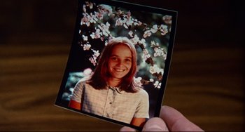 Movie still from “The Wicker Man” (1973), directed by Robin Hardy – A hand holding a picture of a young girl; Extreme Close Up shot, High angle