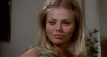 Movie still from “The Wicker Man” (1973), directed by Robin Hardy – A person with long blonde hair; Close Up shot, Over the shoulder angle