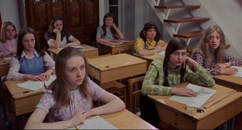 Movie still from “The Wicker Man” (1973), directed by Robin Hardy – A group of girls sitting at desks in a classroom; Medium shot, High angle