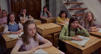 Movie still from “The Wicker Man” (1973), directed by Robin Hardy – A group of girls sitting at desks in a classroom; Medium shot, High angle