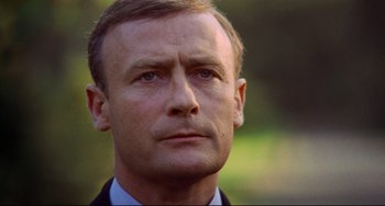 Movie still from “The Wicker Man” (1973), directed by Robin Hardy – A person wearing a suit and tie; Close Up shot, Low angle