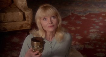 Movie still from “The Wicker Man” (1973), directed by Robin Hardy – A woman holding a paint can in her hand; Close Up shot, Low angle