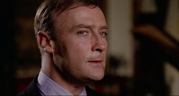 Movie still from “The Wicker Man” (1973), directed by Robin Hardy – A person wearing a suit and tie; Close Up shot, Low angle