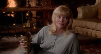 Movie still from “The Wicker Man” (1973), directed by Robin Hardy – A woman with blonde hair is sitting in a room; Close Up shot, Over the shoulder angle