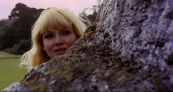 Movie still from “The Wicker Man” (1973), directed by Robin Hardy – A woman with blonde hair leaning against a tree; Close Up shot, Low angle