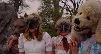 Movie still from “The Wicker Man” (1973), directed by Robin Hardy – A group of people wearing animal head masks; Close Up shot, Low angle
