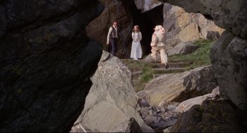 Movie still from “The Wicker Man” (1973), directed by Robin Hardy – A couple of people standing on some rocks; Wide shot, High angle