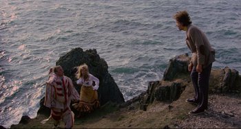 Movie still from “The Wicker Man” (1973), directed by Robin Hardy – A couple of people standing on top of a cliff; Extreme Wide shot, High angle