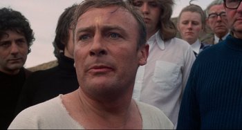 Movie still from “The Wicker Man” (1973), directed by Robin Hardy – A person wearing a white shirt; Close Up shot, Low angle