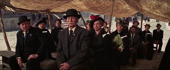 Movie still from “The Wild Bunch” (1969), directed by Sam Peckinpah – An older man and woman in a crowd of people; Medium shot, Low angle
