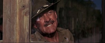 Movie still from “The Wild Bunch” (1969), directed by Sam Peckinpah – An older man wearing a uniform and a hat; Close Up shot, Over the shoulder angle