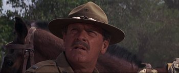 Movie still from “The Wild Bunch” (1969), directed by Sam Peckinpah – An older man wearing a hat and a uniform; Close Up shot, Low angle