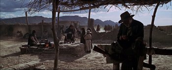 Movie still from “The Wild Bunch” (1969), directed by Sam Peckinpah – A group of people standing on top of a dirt field; Wide shot, Low angle