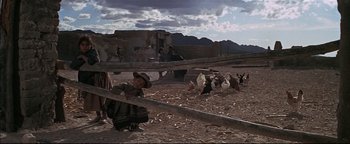 Movie still from “The Wild Bunch” (1969), directed by Sam Peckinpah – A group of people standing on top of a dirt field; Wide shot, Low angle