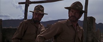 Movie still from “The Wild Bunch” (1969), directed by Sam Peckinpah – A couple of men standing next to each other; Close Up shot, Low angle