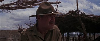 Movie still from “The Wild Bunch” (1969), directed by Sam Peckinpah – An older man wearing a brown hat and a brown shirt; Close Up shot, Low angle