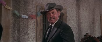 Movie still from “The Wild Bunch” (1969), directed by Sam Peckinpah – An older man wearing a suit and a hat; Close Up shot, Low angle