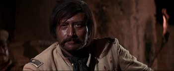 Movie still from “The Wild Bunch” (1969), directed by Sam Peckinpah – A person with a beard and a mustache; Close Up shot, Low angle