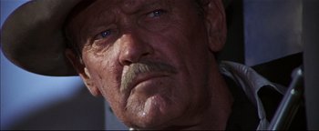 Movie still from “The Wild Bunch” (1969), directed by Sam Peckinpah – An old man with a mustache and a beard; Close Up shot, Low angle