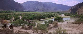 Movie still from “The Wild Bunch” (1969), directed by Sam Peckinpah – A bridge over a river in the middle of the desert; Extreme Wide shot, High angle