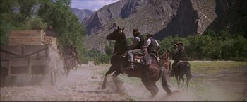 Movie still from “The Wild Bunch” (1969), directed by Sam Peckinpah – A group of men riding on the backs of horses; Wide shot, Low angle