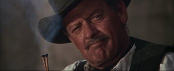 Movie still from “The Wild Bunch” (1969), directed by Sam Peckinpah – An older man with a mustache wearing a cowboy hat; Close Up shot, Low angle