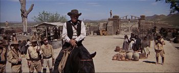 Movie still from “The Wild Bunch” (1969), directed by Sam Peckinpah – A man riding a horse in a desert area; Wide shot, Low angle
