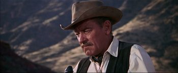 Movie still from “The Wild Bunch” (1969), directed by Sam Peckinpah – An older man in a cowboy hat and vest; Close Up shot, Low angle