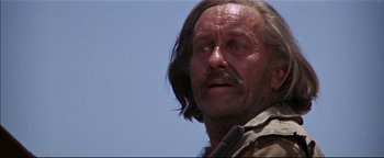 Movie still from “The Wild Bunch” (1969), directed by Sam Peckinpah – A person with long hair and a mustache; Close Up shot, Low angle