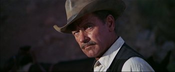 Movie still from “The Wild Bunch” (1969), directed by Sam Peckinpah – A person wearing a cowboy hat; Close Up shot, Low angle