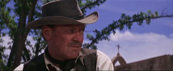 Movie still from “The Wild Bunch” (1969), directed by Sam Peckinpah – A man wearing a cowboy hat and a vest; Close Up shot, Low angle