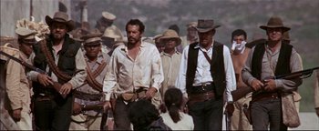 Movie still from “The Wild Bunch” (1969), directed by Sam Peckinpah – A group of men walking down a street; Medium shot, Low angle