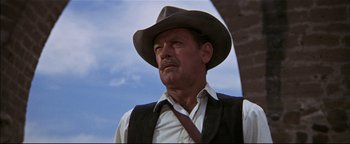 Movie still from “The Wild Bunch” (1969), directed by Sam Peckinpah – An older man wearing a cowboy hat and vest; Close Up shot, Low angle