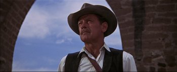 Movie still from “The Wild Bunch” (1969), directed by Sam Peckinpah – An older man wearing a cowboy hat and vest; Close Up shot, Low angle