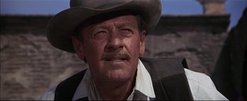 Movie still from “The Wild Bunch” (1969), directed by Sam Peckinpah – An older man wearing a cowboy hat with a mustache; Close Up shot, Low angle