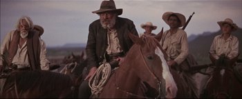 Movie still from “The Wild Bunch” (1969), directed by Sam Peckinpah – An old man sitting on a horse in the middle of a field; Medium shot, Low angle