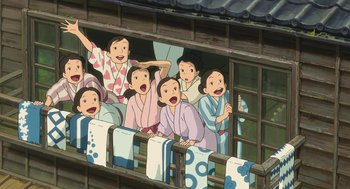 Movie still from “The Wind Rises” (2013), directed by Hayao Miyazaki – A group of people sitting on top of a wooden balcony; Wide shot, High angle