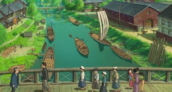 Movie still from “The Wind Rises” (2013), directed by Hayao Miyazaki – A group of people walking across a bridge near boats; Extreme Wide shot, High angle