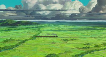 Movie still from “The Wind Rises” (2013), directed by Hayao Miyazaki – A train traveling through a lush green field; Extreme Wide shot, Overhead angle