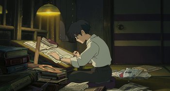 Movie still from “The Wind Rises” (2013), directed by Hayao Miyazaki – A man sitting on the floor writing on a piece of paper in front of a pile of books; Medium shot, High angle