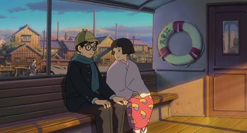 Movie still from “The Wind Rises” (2013), directed by Hayao Miyazaki – A man and a woman sitting on a bench in front of a boat; Medium shot, Low angle