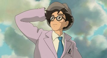 Movie still from “The Wind Rises” (2013), directed by Hayao Miyazaki – An animated man wearing a suit and hat; Medium shot, Low angle