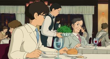 Movie still from “The Wind Rises” (2013), directed by Hayao Miyazaki – An illustration of people sitting at a dinner table; Medium shot, Over the shoulder angle