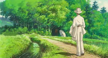 Movie still from “The Wind Rises” (2013), directed by Hayao Miyazaki – A man walking down a dirt road near a forest; Wide shot, High angle
