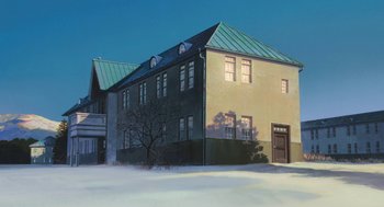 Movie still from “The Wind Rises” (2013), directed by Hayao Miyazaki – A large building with a tree in front of it in the snow; Extreme Wide shot, Low angle