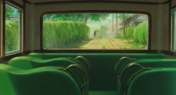 Movie still from “The Wind Rises” (2013), directed by Hayao Miyazaki – A painting of a person walking down a road through a lush green forest; Extreme Wide shot, High angle