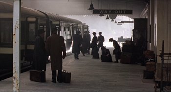 Movie still from “The Wind that Shakes the Barley” (2006), directed by Ken Loach – A group of people standing on a train platform; Extreme Wide shot, High angle